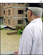 Kathmandu man surveys flooded city street