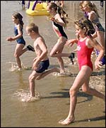 Children running into sea