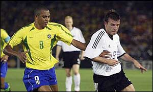 Gilberto Silva challenges Germany's Bernd Schneider 