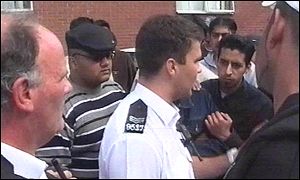 Police officers meet with a group of Muslims