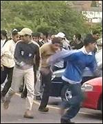 Young men protest against the raid on the mosque
