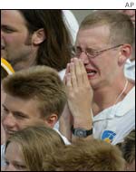A young pilgrim weeps during the welcoming ceremony
