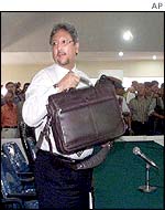 Defence lawyer Felix Tampubolon leaves the court 