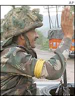 Indian soldier waves at Hindu pilgrims in Kashmir