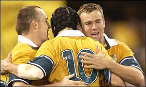 Australian players celebrate as they condemn South Africa to the Tri-Nations wooden spoon