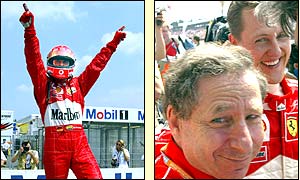 Schumacher raises his arms in triumph at winning pole position and celebrates with Jean Todt