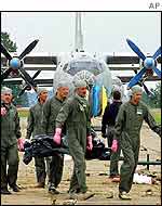 Officials recover victims from the air base