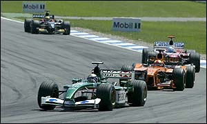 Jaguar's Eddie Irvine leads an early battle for places in the midfield