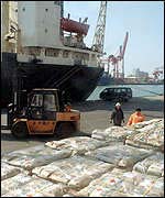 Sacks of food are prepared for distribution