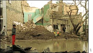 An Iraqi child stands amid the rubble which was left after a 1998 missile attack on Baghdad