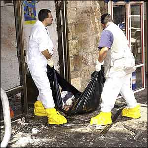 Police carry out the body of the bomber