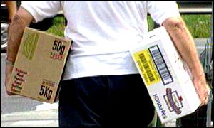 A man carrying a box of alcohol