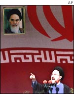Iranian President Mohammad Khatami underneath a picture of Ayatollah Khomeini
