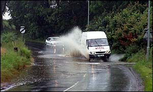 Van going through flooded road