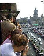 Crowds watch the Pope's cavalcade