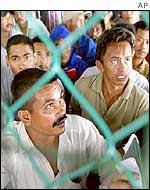 Foreign workers wait to leave Malaysia