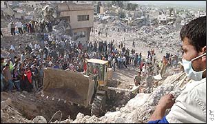 Palestinian looks on as a bulldozer excavates bodies in Jenin