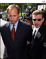 Former WorldCom controller David Myers is loaded into a police car outside of the Federal Building by FBI agents after being arrested