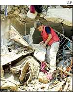 Palestinian boy in debris in Jenin