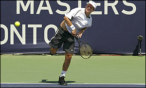 Nalbandian hits the ball back to Henman