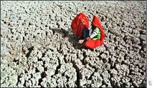 Woman in parched field in Rajasthan