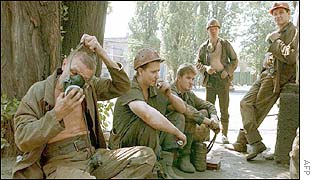 Ukrainian miners check their equipment while waiting for their turn to enter the mine 