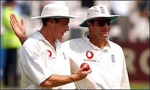 Simon Jones leaves the field with Michael Vaughan