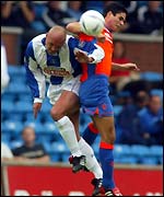 Killie's Steve Fulton (left) battles for possession with Rangers' Mikel Arteta
