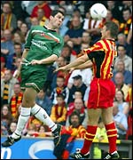 United's Steven Thompson (left) outjumps Thistle's Stephen Craigen