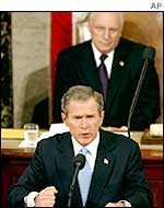 George W Bush with his vice-president behind him