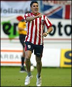 A Sunderland fan runs onto the pitch during the Genk game