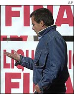 A man walks in front of a store holding a going out of business sale in Montevideo