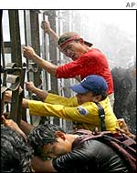 Protesters battle spray from water cannons in Jakarta