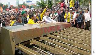 Protesters push over the compound gates