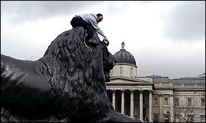 Man doing ironing on statue of a lion
