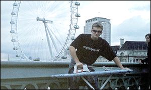 Man ironing in front of London Eye