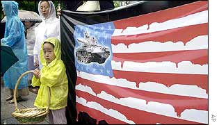 The US flag is depicted as dripping blood in a protest outside the US embassy in Seoul