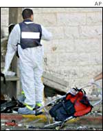 An Israeli forensic expert at the site of a suicide bombing in Jerusalem on 19 June.