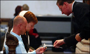 Holly's parents Nicola and Kevin Wells and vicar Tim Alban Jones