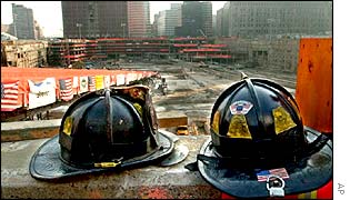 Firefighters helmets sit on a concrete ledge overlooking ground zero at the World Trade Center site 