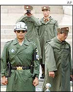 North Korean soldiers photograph South Korean guards
