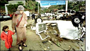 Algerians pick their way past flood damage