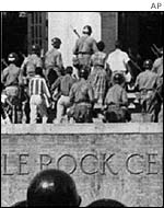 Soldiers accompany nine black students to school in Little Rock, Arkansas