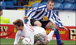 Bjarni Gudjonsson loses out to Sheffield Wednesday's Alan Quinn. 