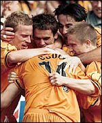 James Gould is mobbed by his team-mates