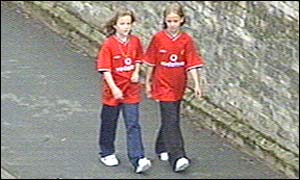 The two girls walk through the town