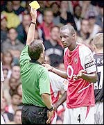 Arsenal's Patrick Vieira is booked by Alan Wiley