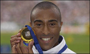Colin Jackson displays his 110m hurdles gold medal from the 2002 European Championships