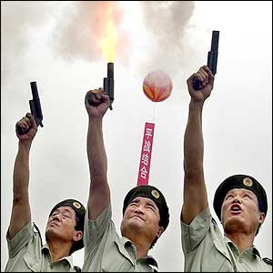 Soldiers shoot flares to launch an air-raid drill in Shanghai