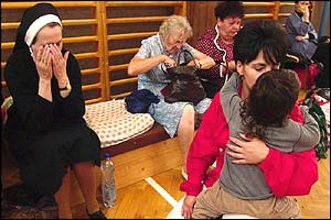 Evacuees in a school gym hall